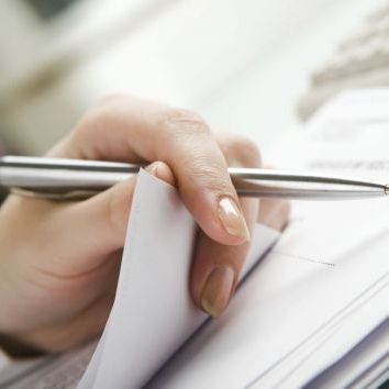 pen in hand reading documents