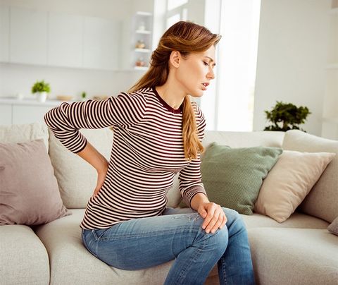 Woman Suffering from Back Pain — Dodge City, KS — Phillips Chiropractic & Physical Therapy Center Woman Suffering from Back Pain — Dodge City, KS — Phillips Chiropractic & Physical Therapy Center