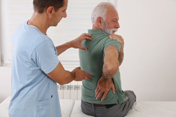 Spine Physical Therapist and Patient — Dodge City, KS — Phillips Chiropractic & Physical Therapy Center