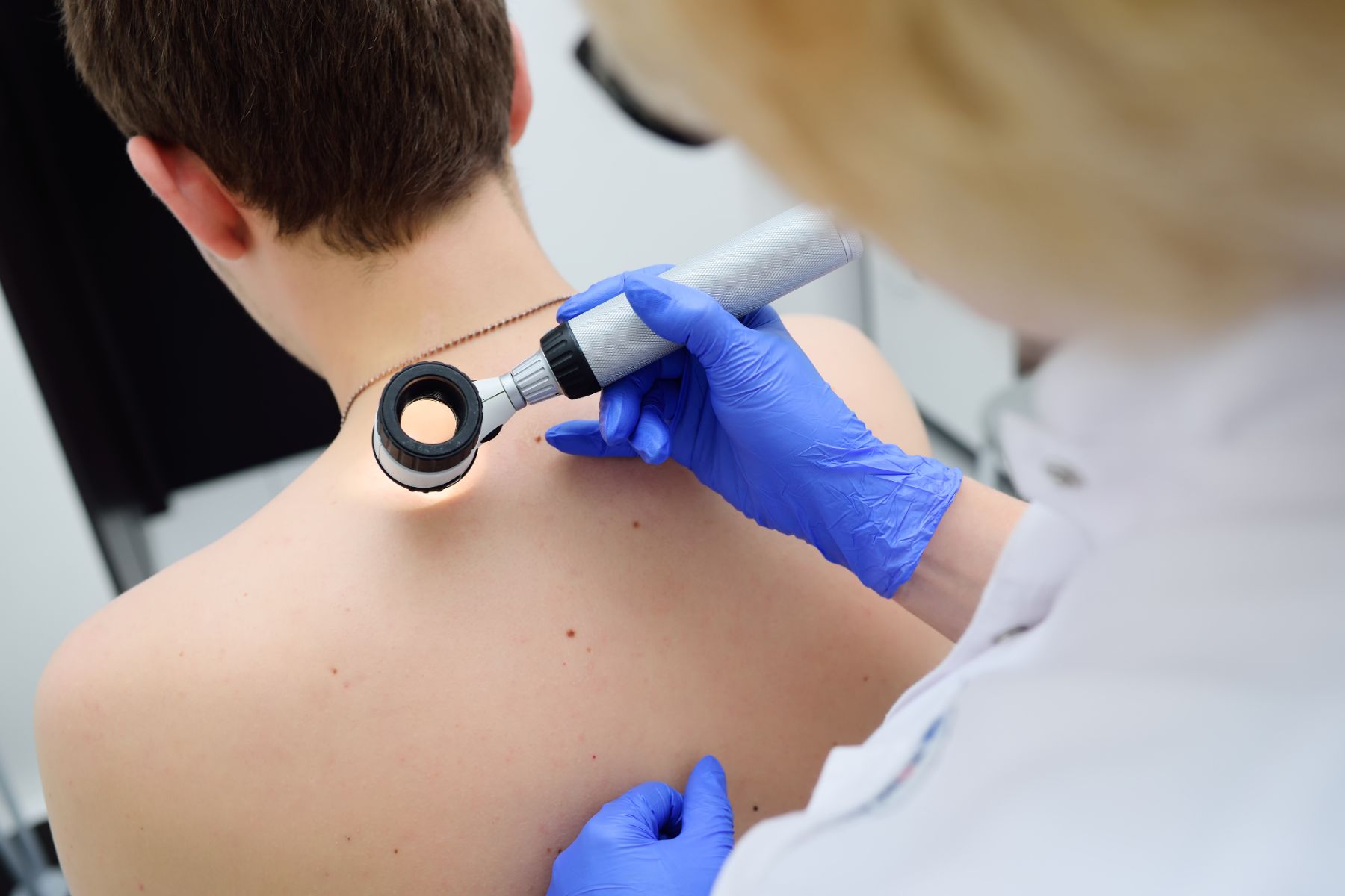 dermatologist examining patient's skin at Skin Cancer Center of Central Florida