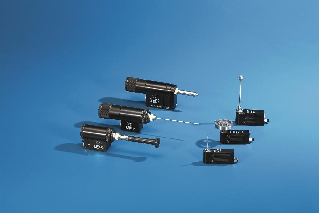 A group of small black objects are sitting on a blue surface.