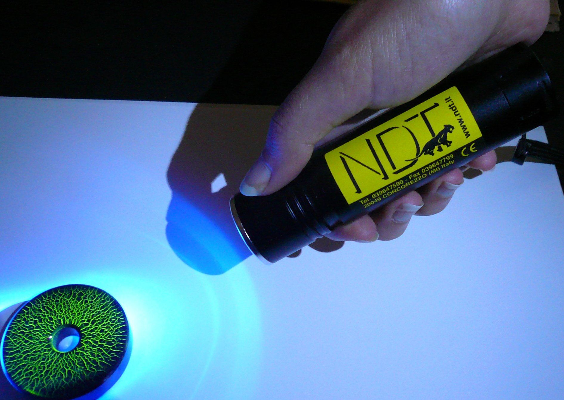 A person is holding a bottle that says ndt on it