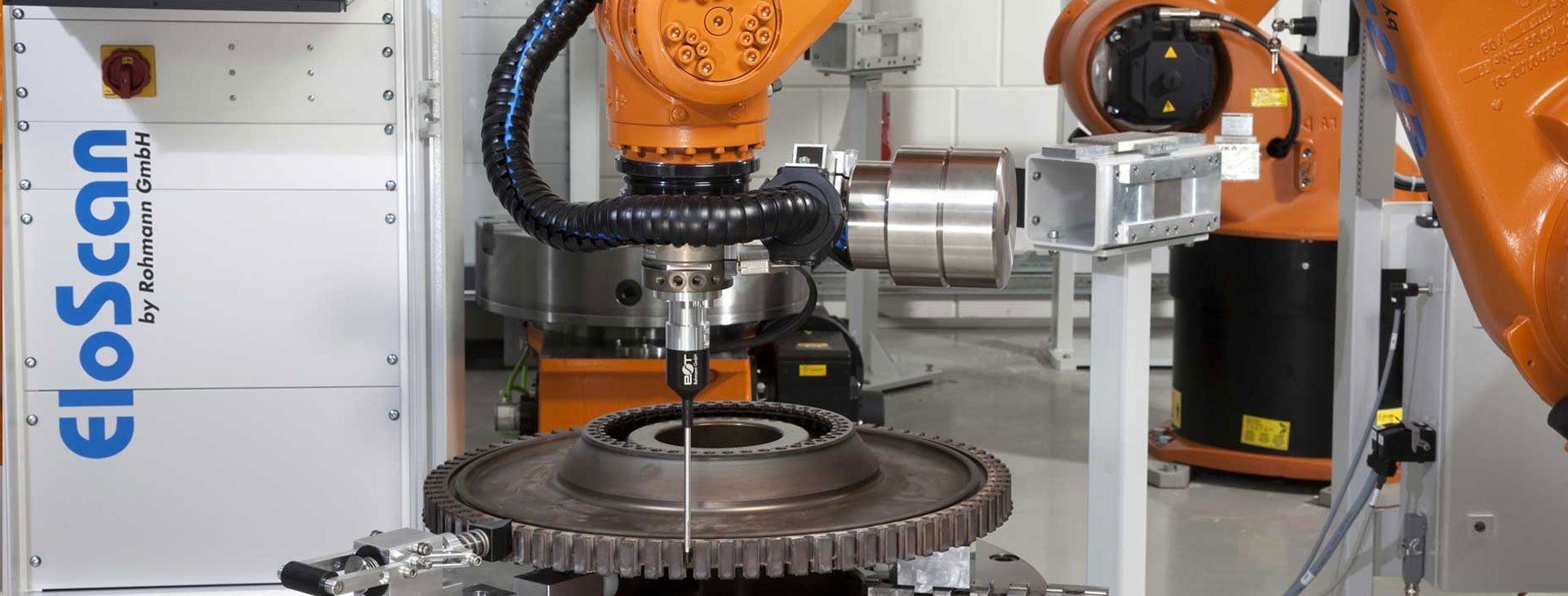 A robot is working on a gear in a factory.