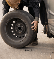A mechanic taking off a wheel