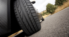 Ground level view of the near side front wheel of a car