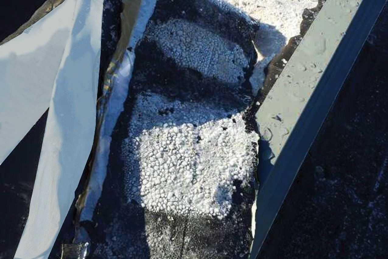 Frost on self-adhered flashing found under metal coping on WickRight General Contracting customer's wet split face block wall