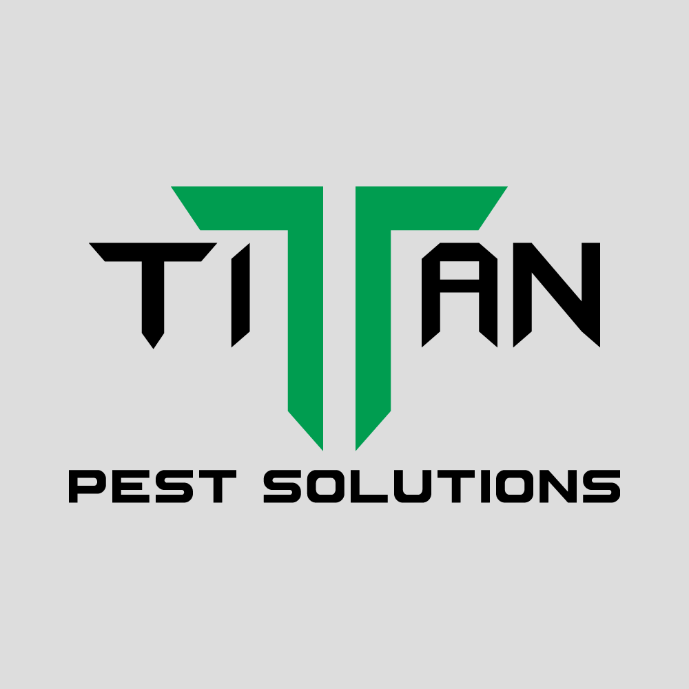 A green and black logo for titan pest solutions