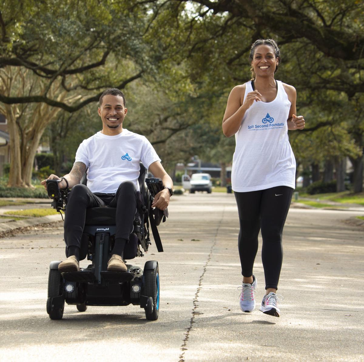 A man in a wheelchair is being pushed by a woman