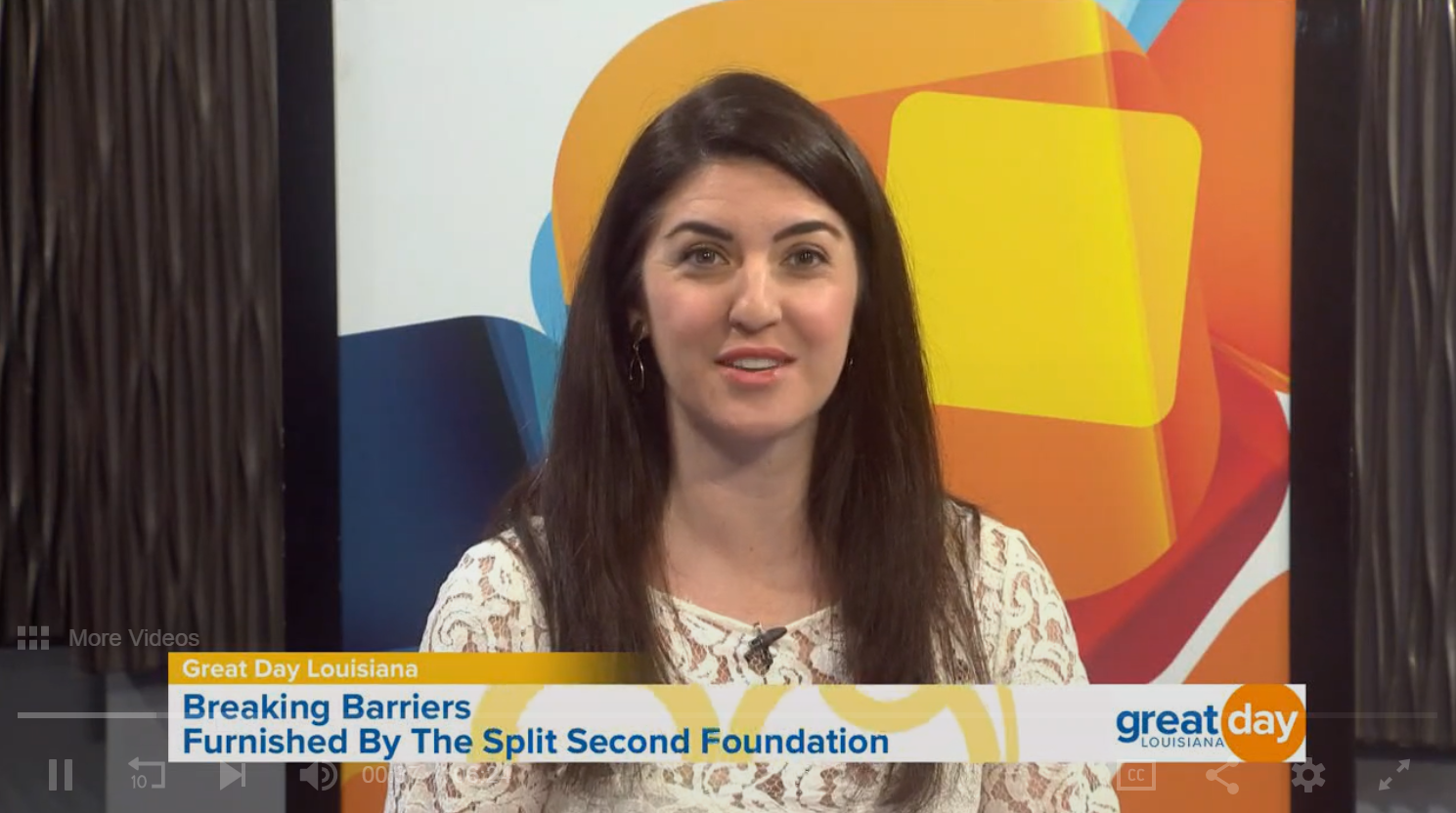 A woman is being interviewed on a tv show about breaking barriers