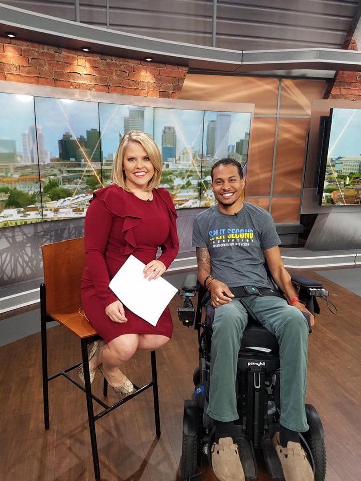 A woman is sitting on a chair next to a man in a wheelchair.
