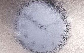 Watch seen through glossy glass