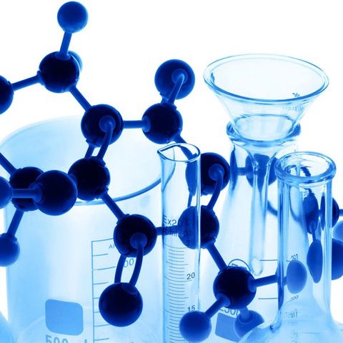 Laboratory glass with atom model on the white.