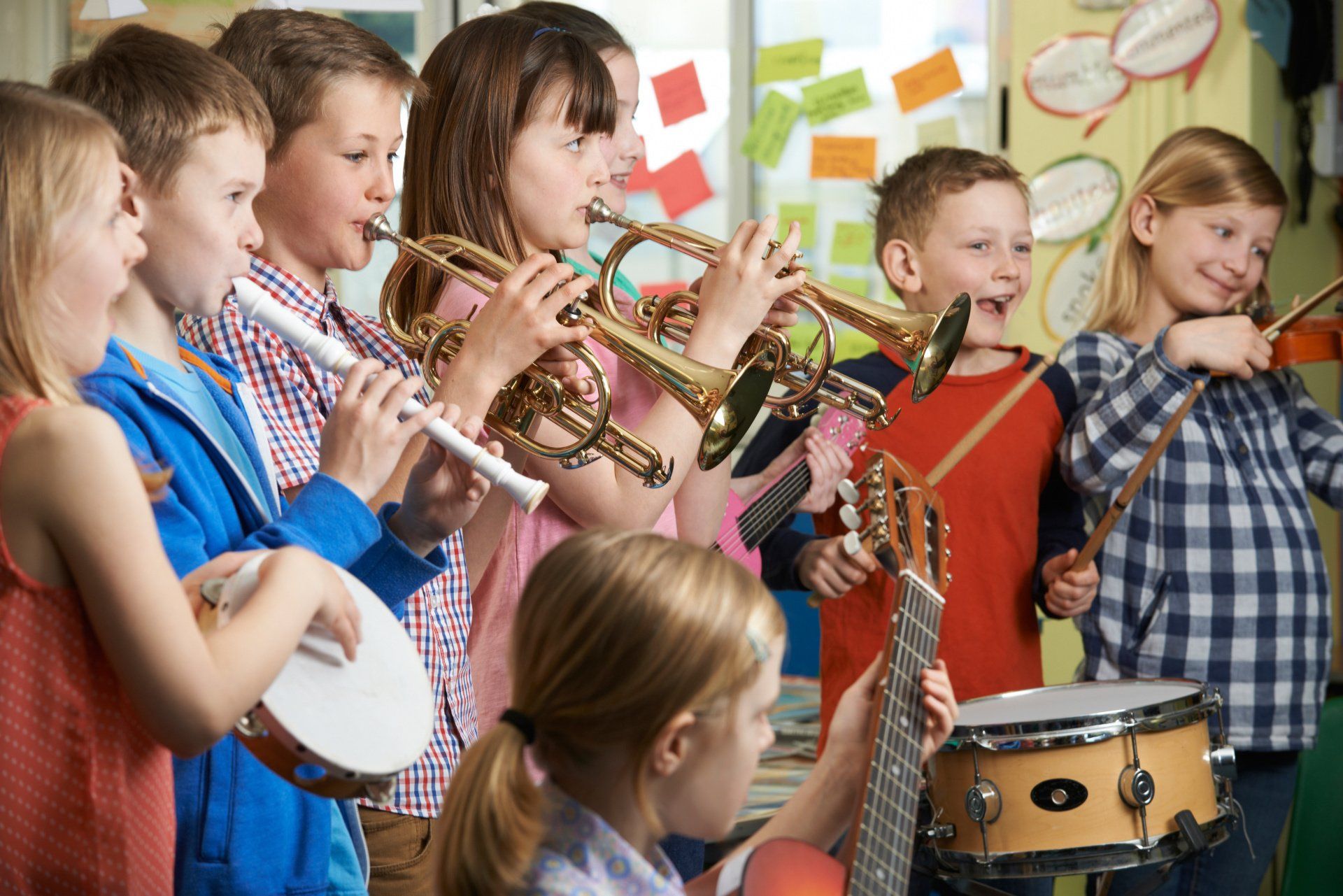 Children playing a variety of instruments