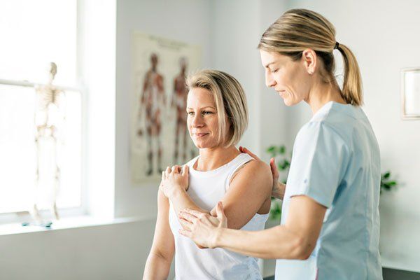 Woman Worker and Client — Springfield, MO — James River Chiropractic & Wellness