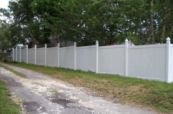 6ft Gothic style PVC privacy fence stepped downhill