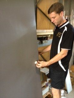 man installing a doorknob