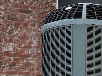 Repair - High efficiency modern AC-heater unit on brick wall background in Brewer, ME