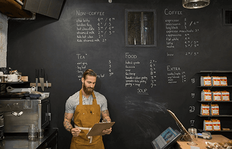 a cafe that has its menu written on a black board