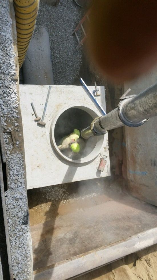 sanitation — two worker checking sewer in Cleveland, OH