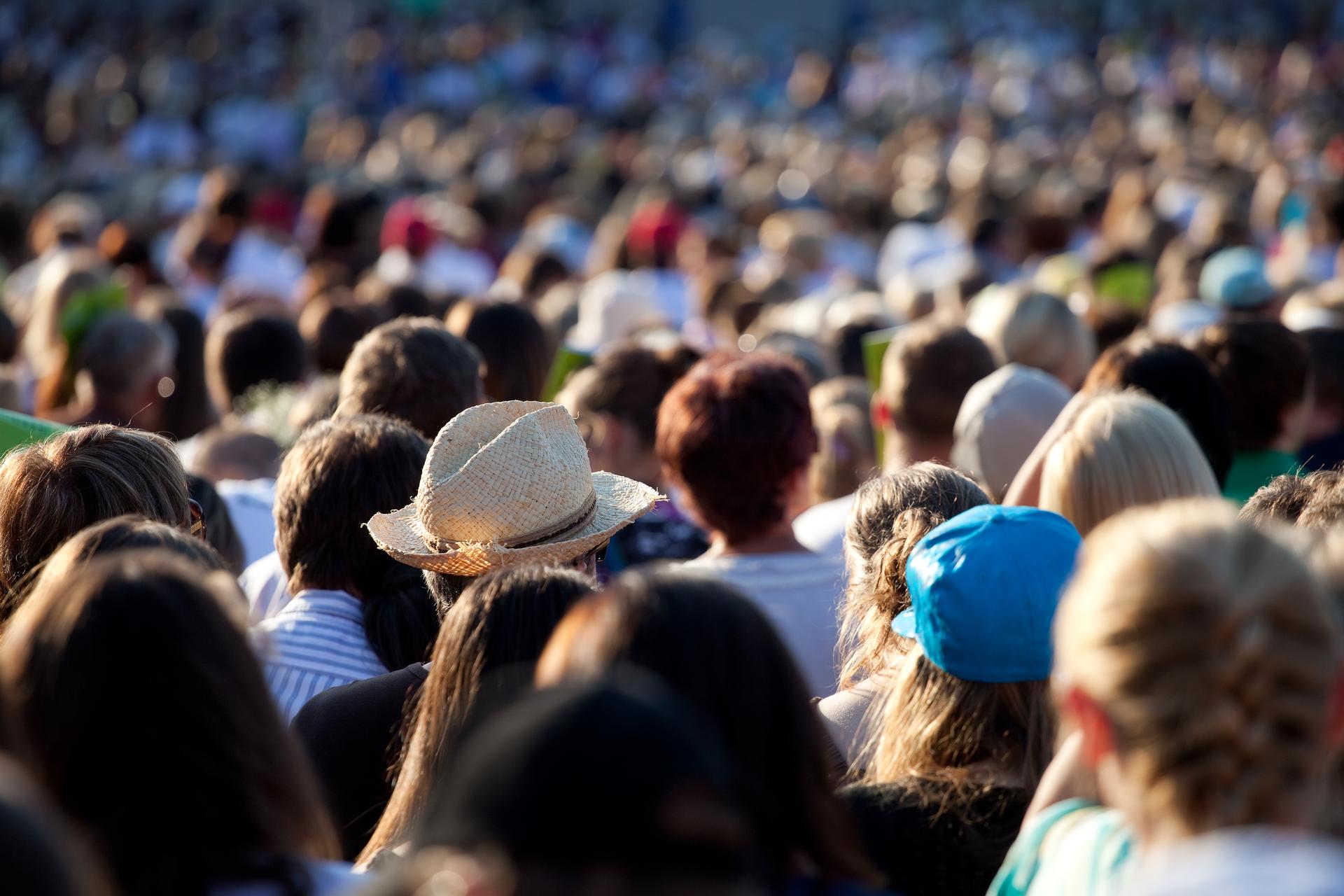 A large crowd of people are sitting in a stadium.