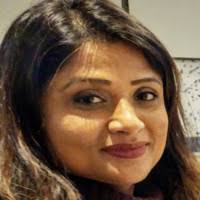 A close up of a woman 's face with a smile on her face.