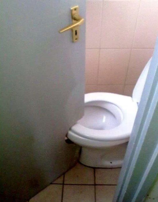 A toilet sits in a bathroom next to a door