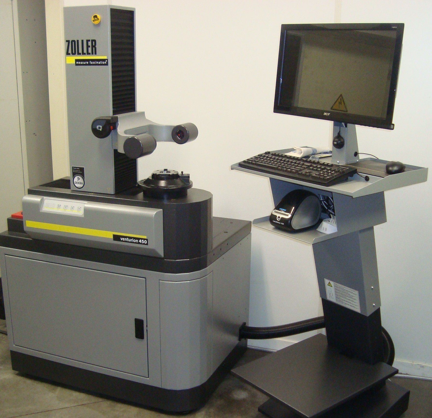 A toiller machine sits next to a computer on a stand