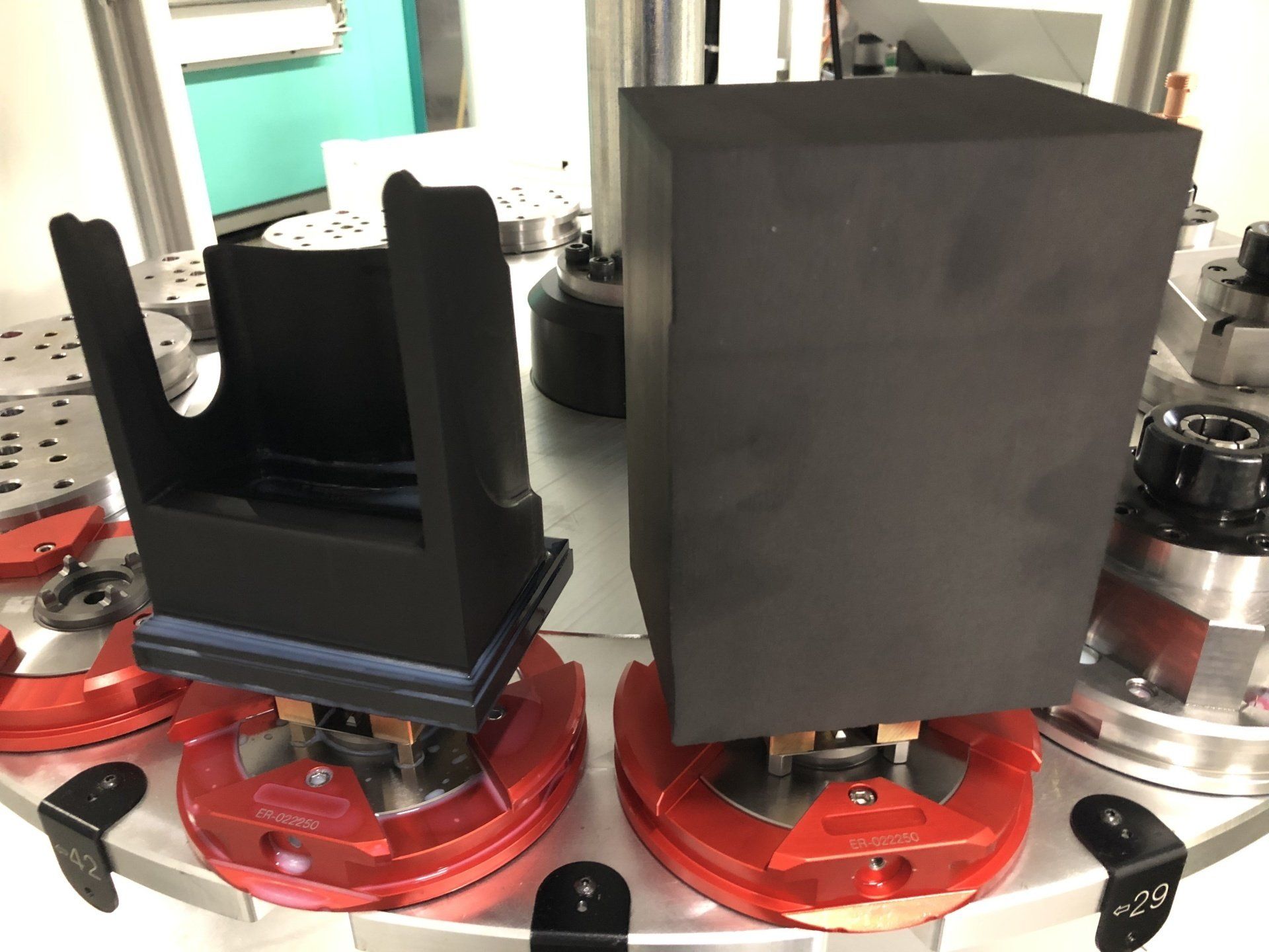 Two black boxes are sitting on top of a machine.