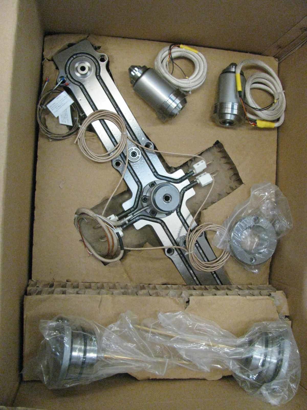 A cardboard box filled with a bunch of metal parts