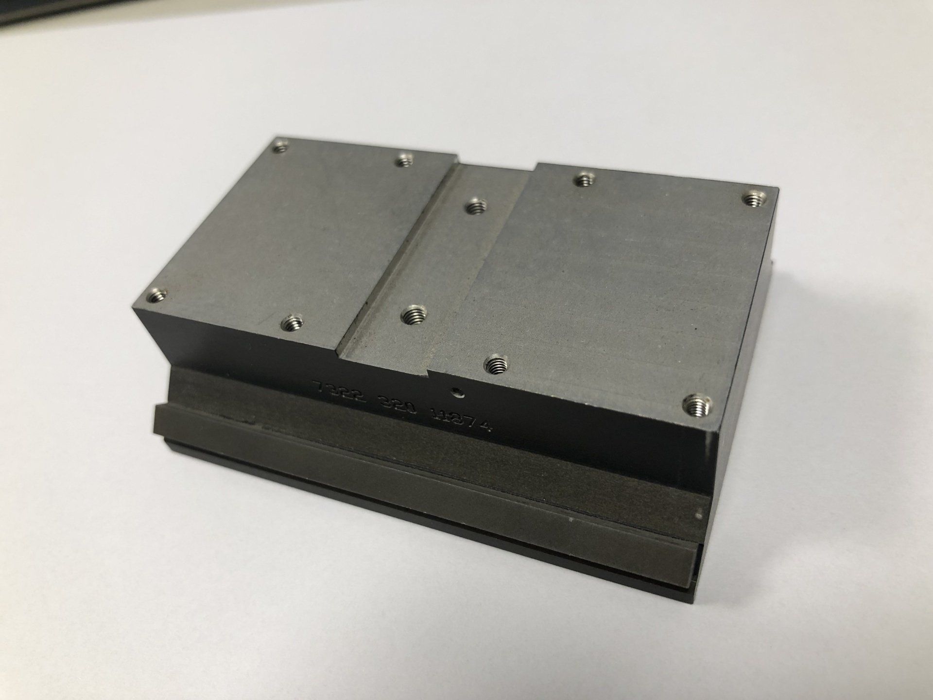 A small piece of metal is sitting on a white surface.