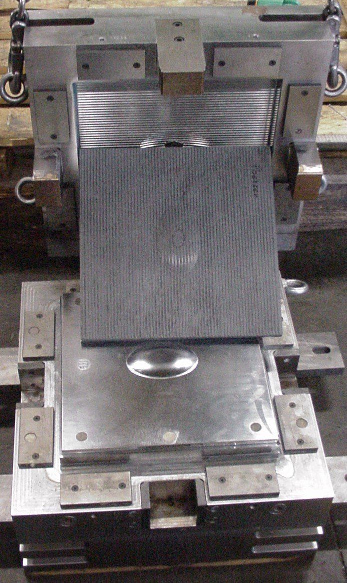 A piece of metal is sitting on top of a machine.