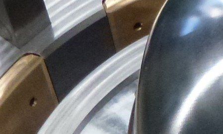 A close up of a metal object with holes in it.
