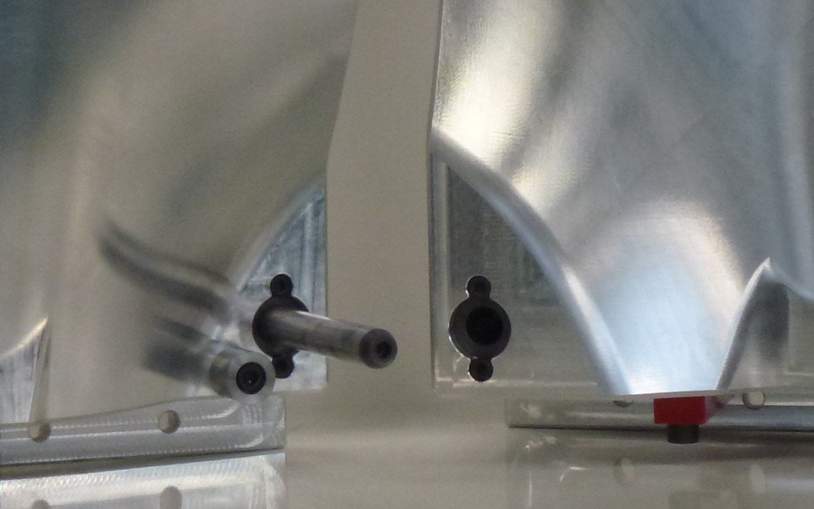 A close up of two plastic bags with holes in them on a table.