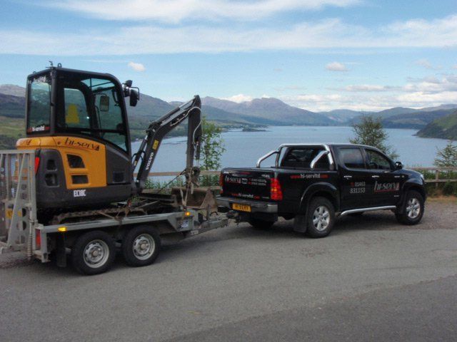 black car and Hi-Serv vehicle