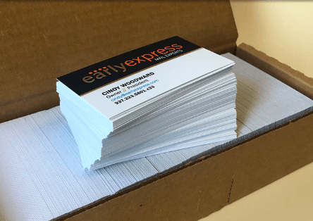 Stack of Citibank Express business cards in an open cardboard box