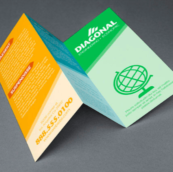 Three colorful folded brochures with green, orange, and teal panels on a gray background