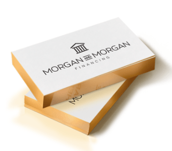 Stacked white and gold Morgan & Morgan Fine Law boxes on a white background