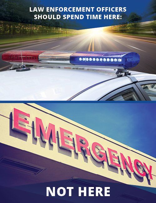 Police car with lights on highway, below an emergency room sign, emphasizing emergency room over highway.