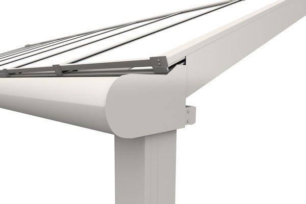 A close-up view of the white metal support post, gutter, and roof frame of a modern outdoor pergola structure.