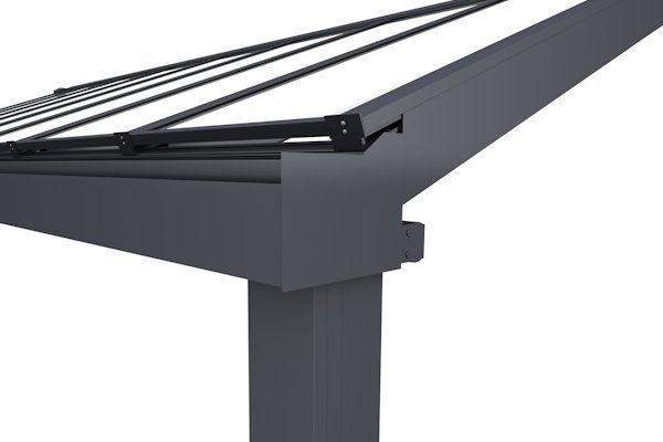 A close-up view of the corner joint of a dark grey metal pergola structure, showing the post, gutter, and roof frame.