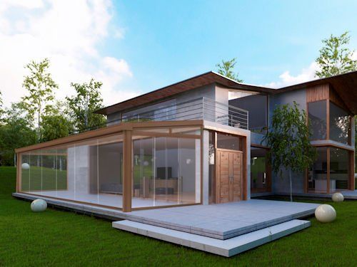 A modern house with glass-walled sunroom, wood trim, and a raised patio, situated in a green, tree-filled setting.