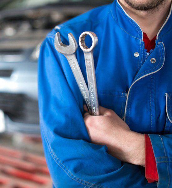 Repair Man Holding a Wrench — Holly Hill, FL — Whitt Automotive for Auto Repair Services Repair Man Holding a Wrench — Holly Hill, FL — Whitt Automotive for Auto Repair Services