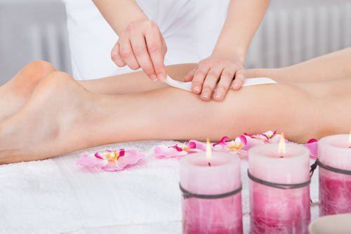 Woman undergoing waxing treatment at our salon