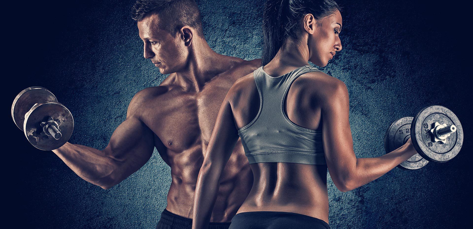A man and a woman are lifting dumbbells together.