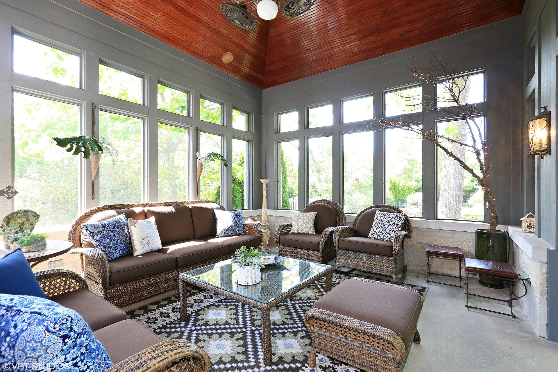 A living room with a lot of windows and furniture