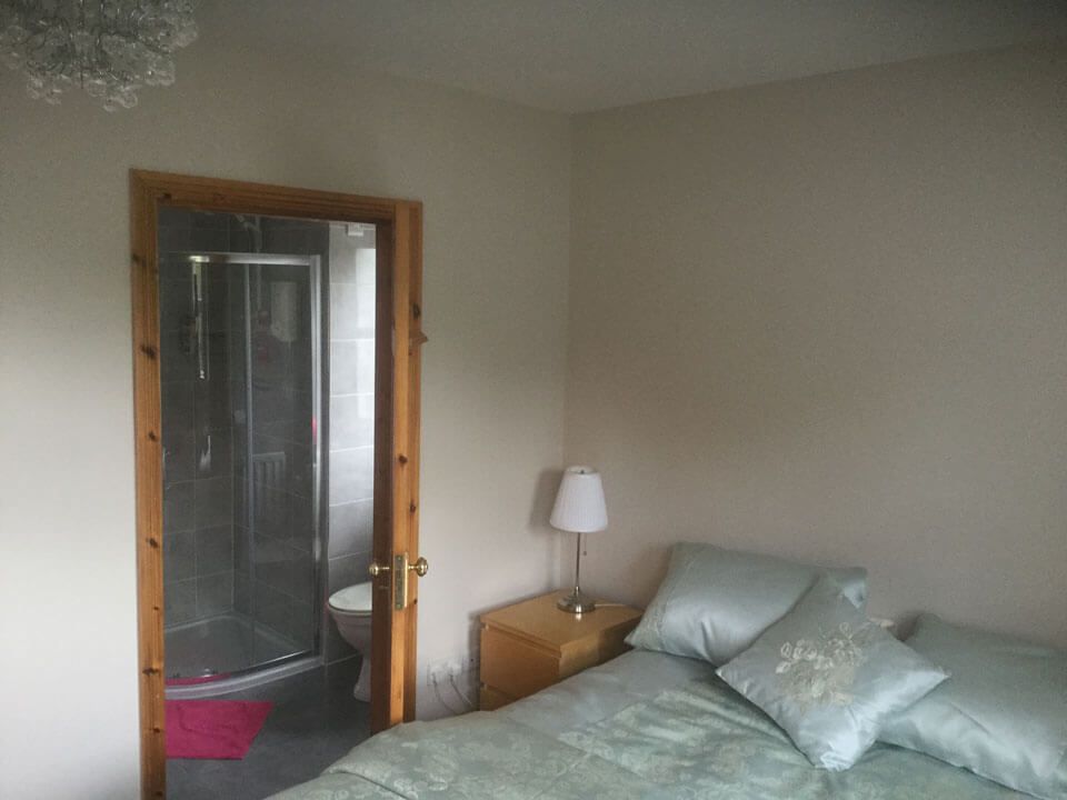 Five Oaks B&B Guest Bedroom with a glimpse of the bathroom