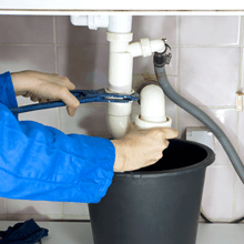 Plumber removing a U-bend