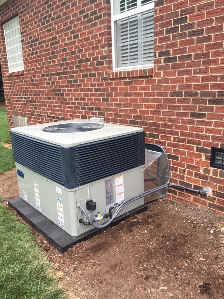Air conditioner unit outside a brick building.