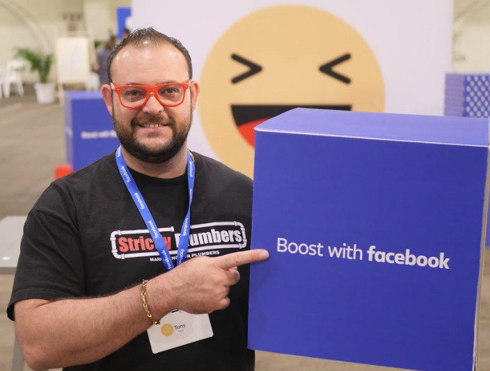 A man holding a box that says boost with facebook