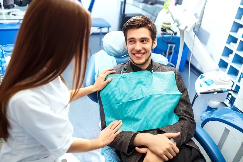 Man at the dentist's chair during a dental procedure Man at the dentist's chair during a dental procedure